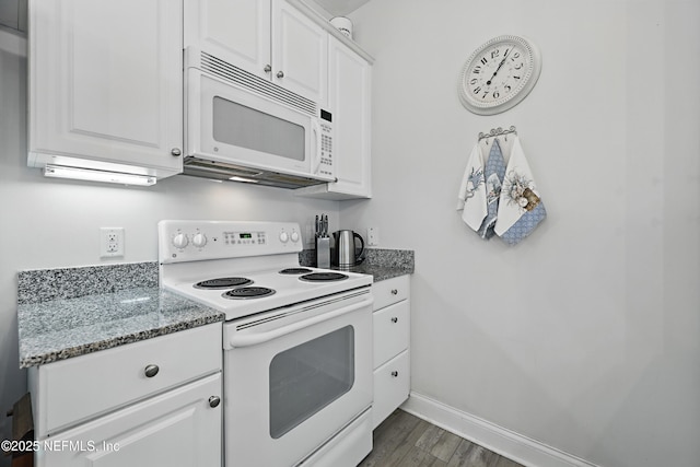 115 Legendary Dr Unit 106, Saint Augustine, FL 32902 - kitchen featuring white appliances, baseboards, dark wood-style floors, white cabinetry, and stone counters
