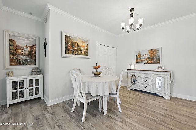 115 Legendary Dr Unit 106, Saint Augustine, FL 32902 - dining space with crown molding, light wood-style flooring, and a chandelier
