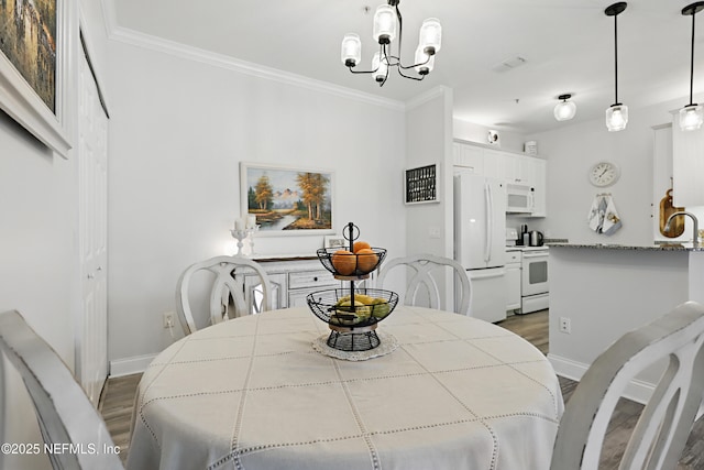 115 Legendary Dr Unit 106, Saint Augustine, FL 32902 - dining area featuring crown molding, baseboards, and light wood-type flooring
