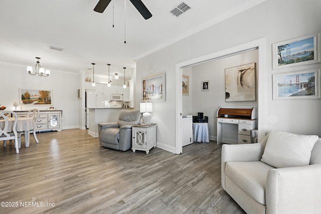115 Legendary Dr Unit 106, Saint Augustine, FL 32902 - living room featuring visible vents, ceiling fan with notable chandelier, and light wood-type flooring