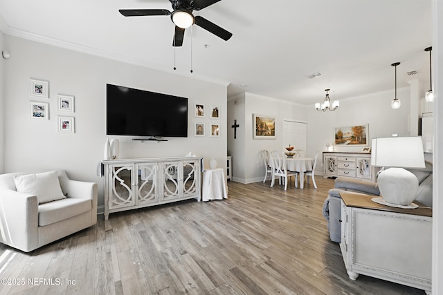 115 Legendary Dr Unit 106, Saint Augustine, FL 32902 - living area with crown molding, light wood-style flooring, ceiling fan with notable chandelier, baseboards, and visible vents