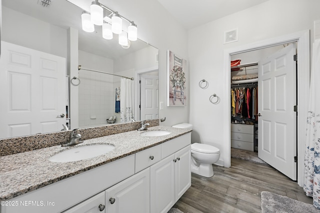 115 Legendary Dr Unit 106, Saint Augustine, FL 32902 - full bath with a sink, curtained shower, wood finished floors, and visible vents