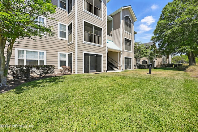 115 Legendary Dr Unit 106, Saint Augustine, FL 32902 - rear view of property featuring a lawn