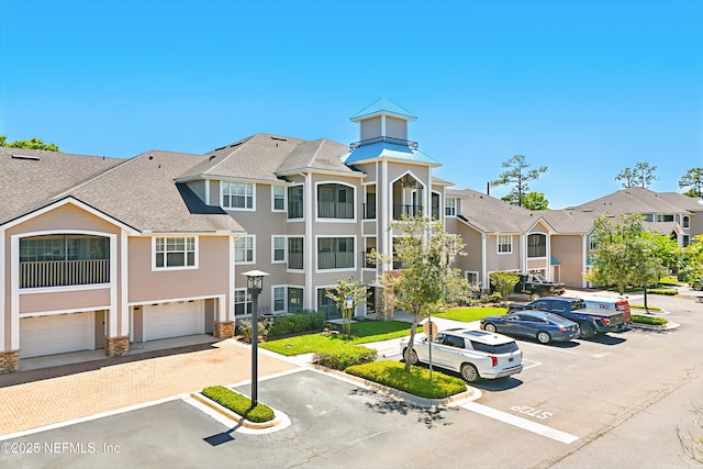 115 Legendary Dr Unit 106, Saint Augustine, FL 32902 - view of building exterior with a residential view, uncovered parking, and a garage