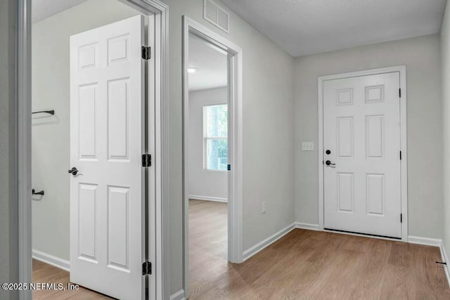 5454 Amazon Ave, Jacksonville, FL 32254 - foyer entrance featuring baseboards, wood finished floors, and visible vents
