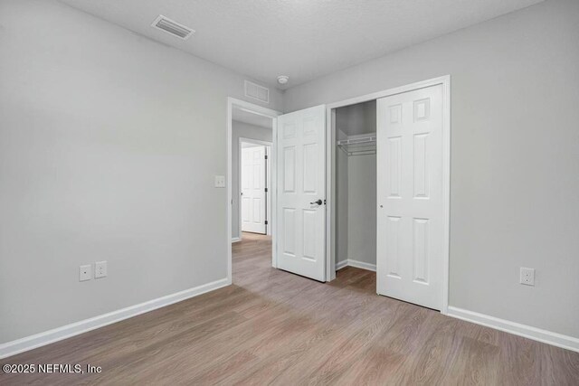 5454 Amazon Ave, Jacksonville, FL 32254 - unfurnished bedroom featuring baseboards, wood finished floors, visible vents, and a closet