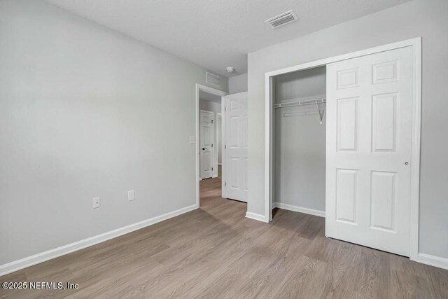 5454 Amazon Ave, Jacksonville, FL 32254 - unfurnished bedroom featuring a closet, light wood-style flooring, visible vents, and baseboards