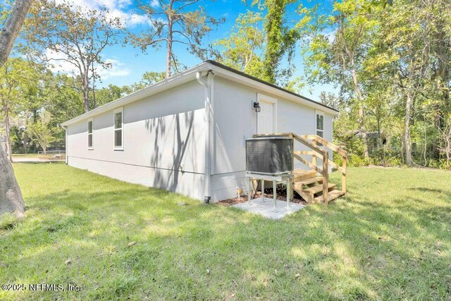 5454 Amazon Ave, Jacksonville, FL 32254 - back of house featuring a yard