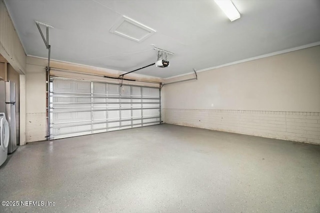 garage with freestanding refrigerator and a garage door opener