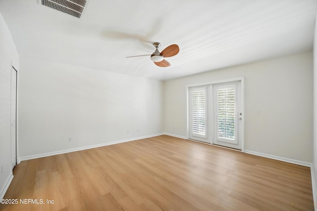 spare room with ceiling fan, baseboards, visible vents, and light wood-type flooring