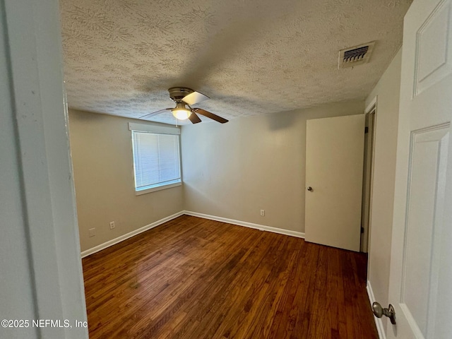 spare room with a ceiling fan, wood finished floors, and a textured ceiling