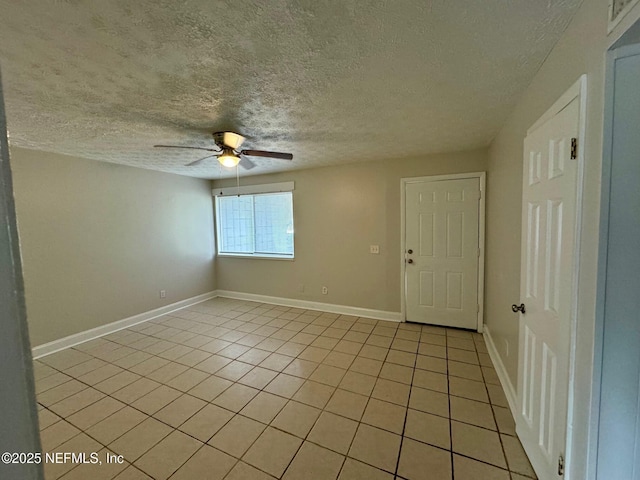 unfurnished room featuring ceiling fan, a textured ceiling, and light tile patterned floors