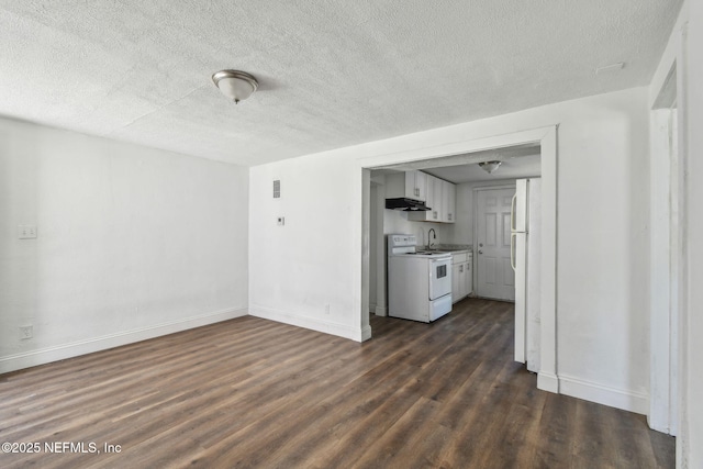 1330 Barnett St, Jacksonville, FL 32209 - unfurnished living room featuring a textured ceiling, dark wood-style flooring, and baseboards