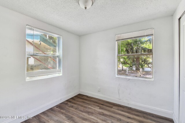 1330 Barnett St, Jacksonville, FL 32209 - unfurnished room featuring dark wood-style floors, a textured ceiling, and baseboards
