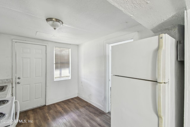 1330 Barnett St, Jacksonville, FL 32209 - kitchen featuring light countertops, dark wood-style flooring, baseboards, and white appliances