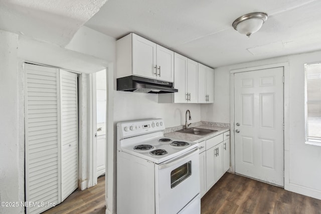 1330 Barnett St, Jacksonville, FL 32209 - kitchen with electric stove, dark wood finished floors, under cabinet range hood, white cabinets, and a sink