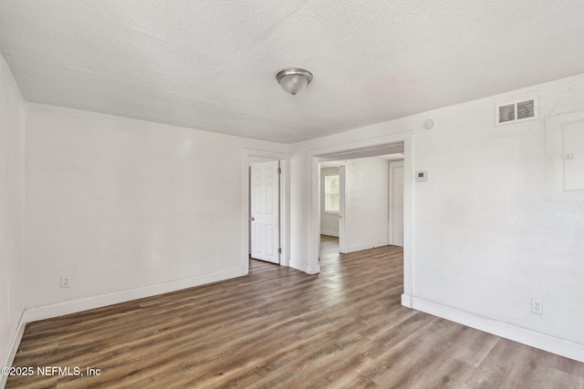 1330 Barnett St, Jacksonville, FL 32209 - empty room with a textured ceiling, visible vents, wood finished floors, and baseboards