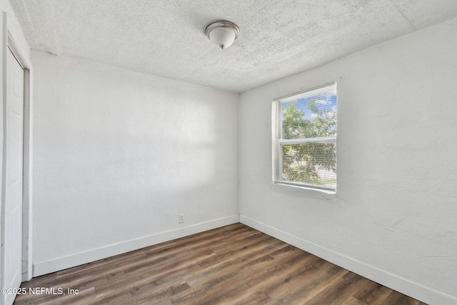 1330 Barnett St, Jacksonville, FL 32209 - spare room featuring dark wood-style floors, a textured ceiling, and baseboards