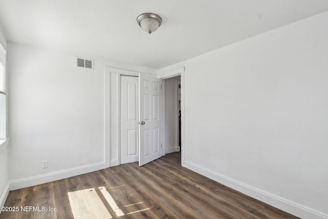 1330 Barnett St, Jacksonville, FL 32209 - unfurnished bedroom with dark wood-style flooring, visible vents, and baseboards