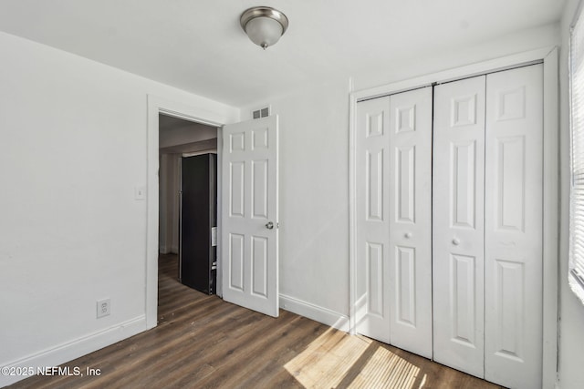 1330 Barnett St, Jacksonville, FL 32209 - unfurnished bedroom with dark wood-style floors, a closet, visible vents, and baseboards