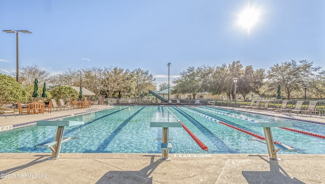pool featuring a patio and fence