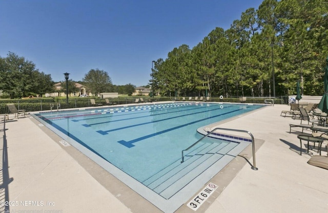 pool with fence and a patio area