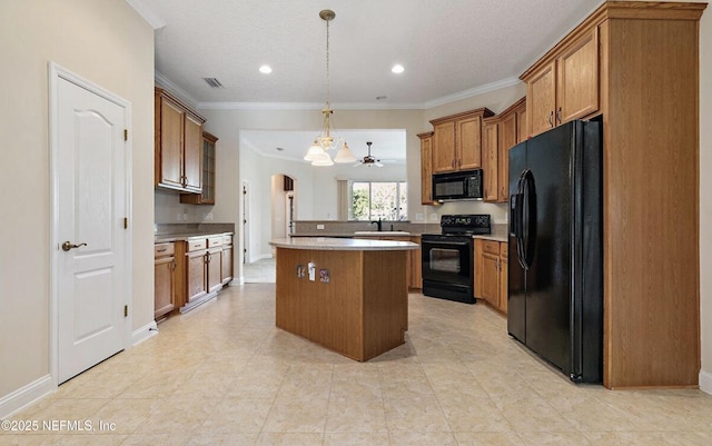 kitchen with brown cabinetry, ornamental molding, a center island, a sink, and black appliances