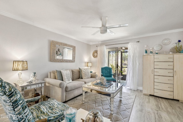 living room featuring ceiling fan, crown molding, and light wood-style floors
