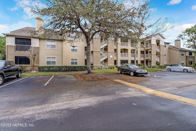 view of building exterior with uncovered parking