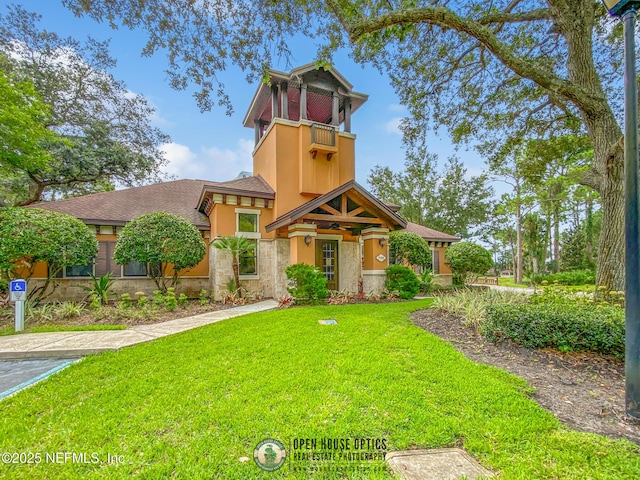 100 Fairway Park Blvd Unit 1101, Ponte Vedra Beach, FL 32082 - victorian home featuring stucco siding, a front yard, stone siding, and roof with shingles
