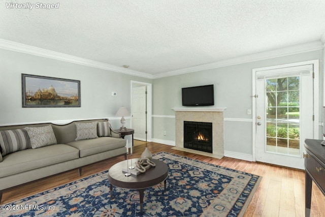 100 Fairway Park Blvd Unit 1101, Ponte Vedra Beach, FL 32082 - living room with a textured ceiling, wood-type flooring, a fireplace with flush hearth, and crown molding