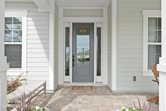 view of exterior entry featuring a porch