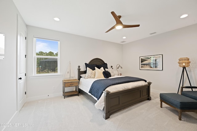 bedroom featuring visible vents, baseboards, ceiling fan, and light colored carpet