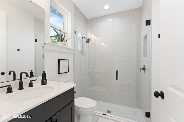 full bathroom with vanity, recessed lighting, a stall shower, and toilet