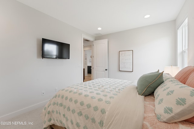 bedroom with baseboards, recessed lighting, and light carpet