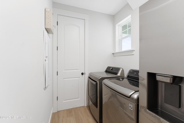 laundry area featuring laundry area, light wood finished floors, and independent washer and dryer