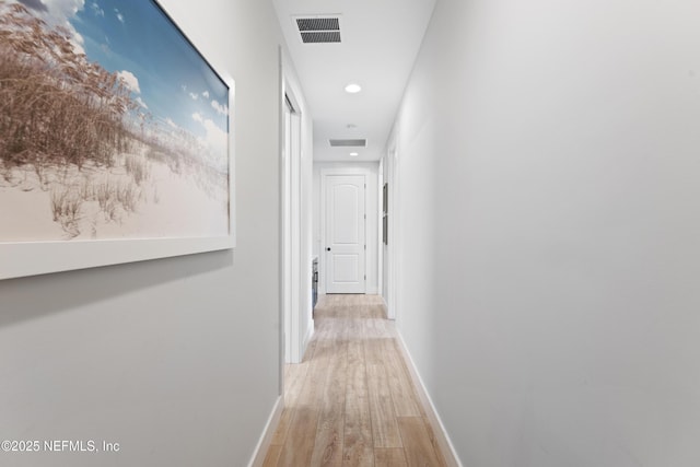 hallway featuring recessed lighting, baseboards, visible vents, and light wood-type flooring