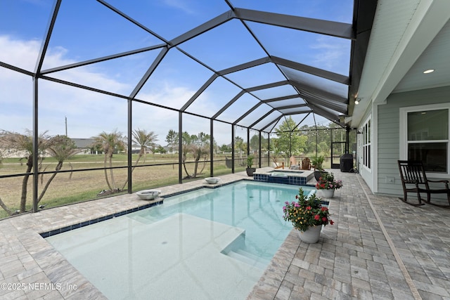 view of swimming pool featuring a lanai, a patio area, and a pool with connected hot tub