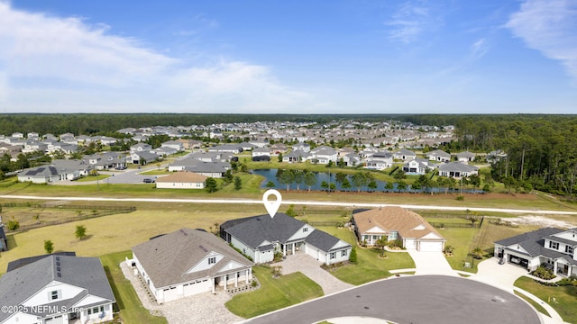 birds eye view of property with a water view and a residential view