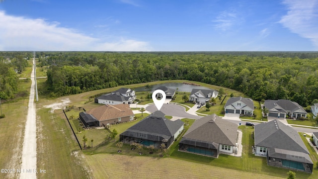 aerial view with a water view, a residential view, and a forest view