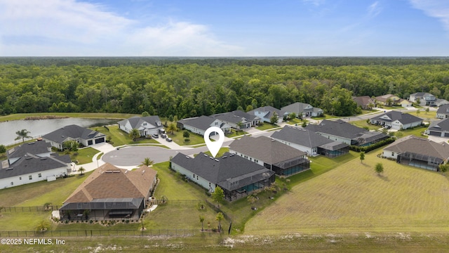 birds eye view of property featuring a water view, a view of trees, and a residential view