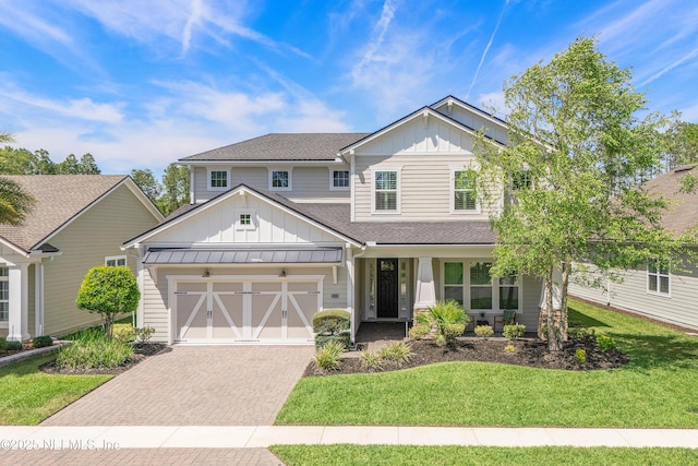314 Freshwater Dr, Saint Johns, FL 32259 - craftsman-style house with decorative driveway, board and batten siding, an attached garage, a front yard, and roof with shingles