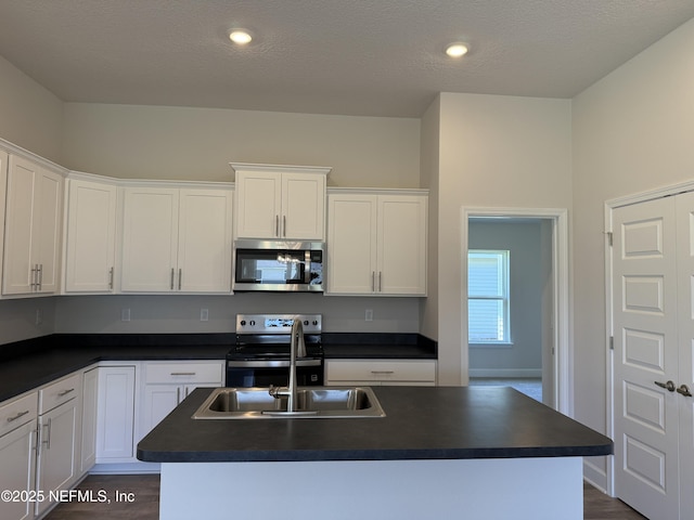 8340 Helmsley Blvd, Jacksonville, FL 32219 - kitchen featuring appliances with stainless steel finishes, dark countertops, white cabinetry, and recessed lighting