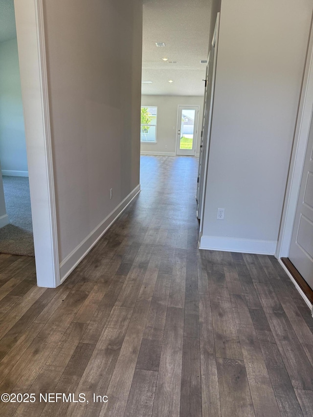 8340 Helmsley Blvd, Jacksonville, FL 32219 - hall with dark wood-type flooring and baseboards