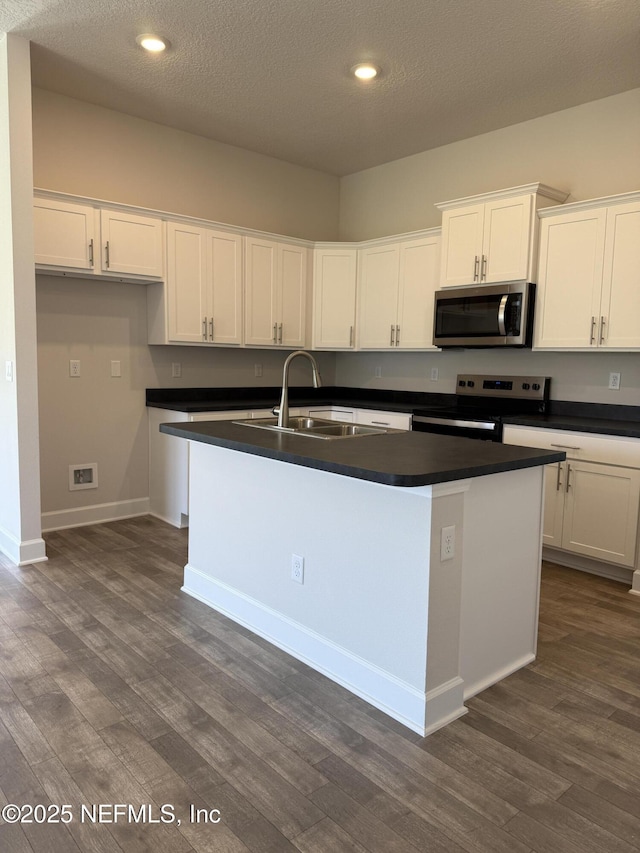 8340 Helmsley Blvd, Jacksonville, FL 32219 - kitchen featuring appliances with stainless steel finishes, a sink, dark wood-type flooring, a kitchen island with sink, and recessed lighting