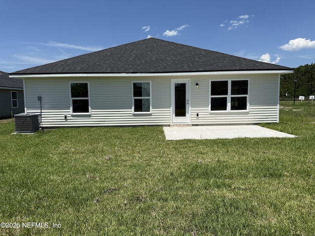 8340 Helmsley Blvd, Jacksonville, FL 32219 - back of house with central AC unit, roof with shingles, a patio, and a lawn