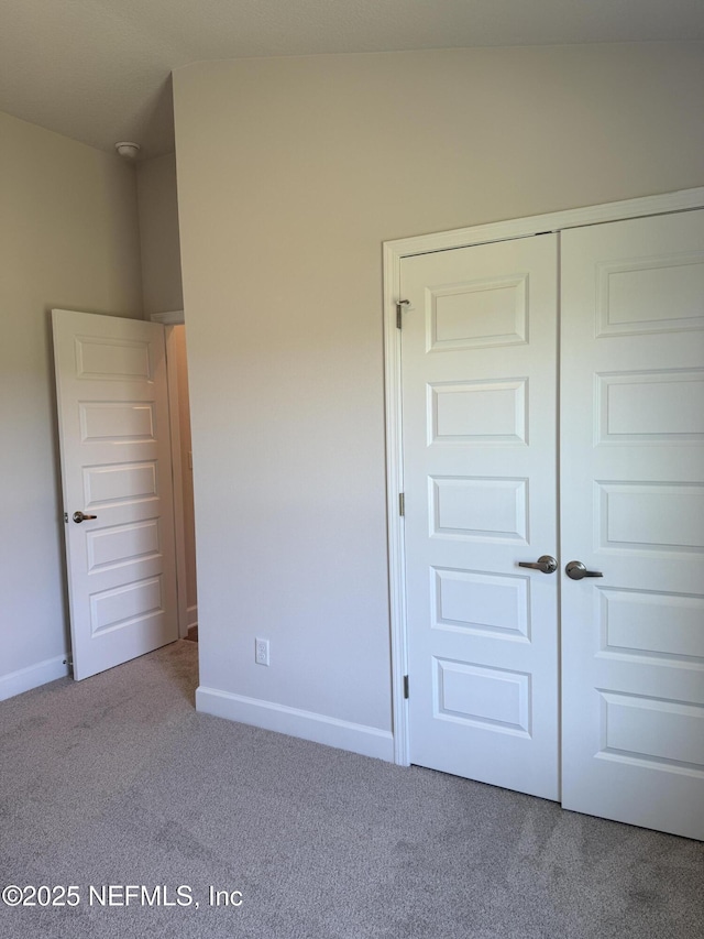 8340 Helmsley Blvd, Jacksonville, FL 32219 - unfurnished bedroom featuring carpet floors, baseboards, and a closet