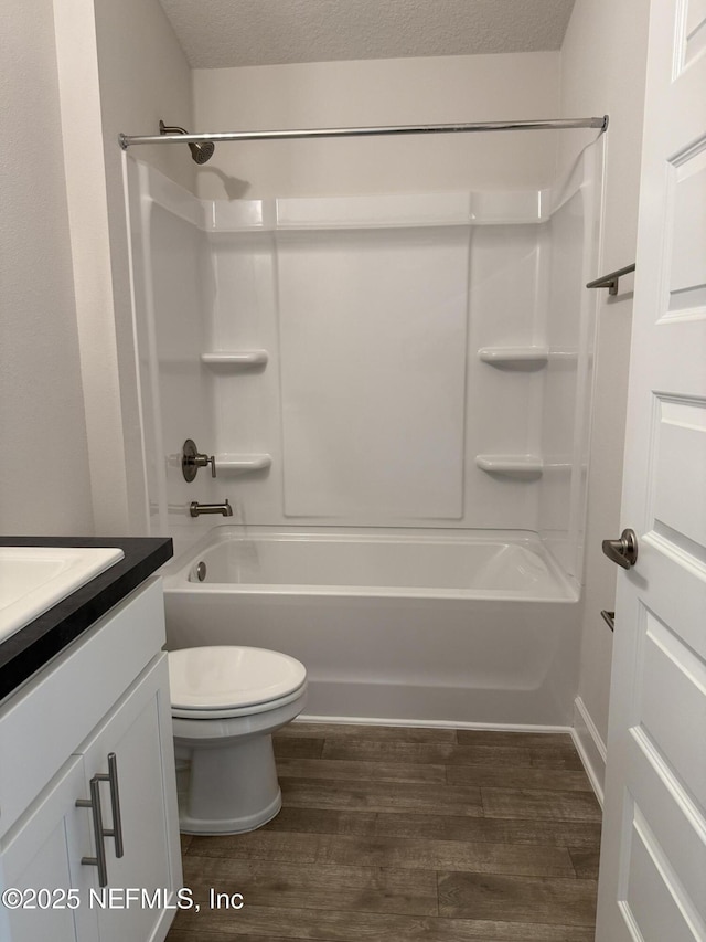8340 Helmsley Blvd, Jacksonville, FL 32219 - bathroom with vanity, wood finished floors, bathing tub / shower combination, toilet, and a textured ceiling