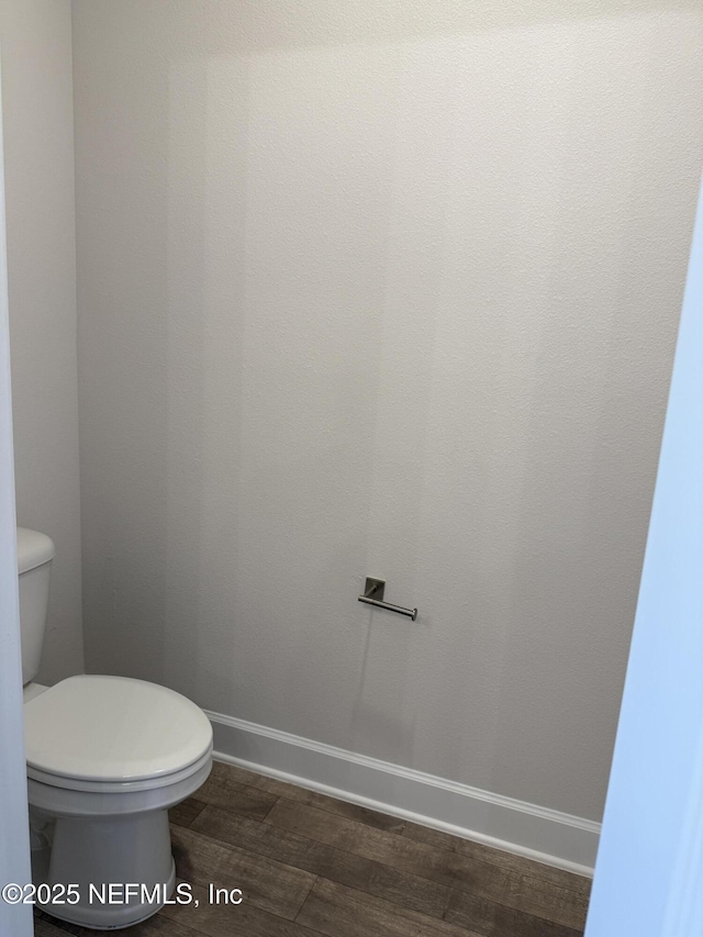 8340 Helmsley Blvd, Jacksonville, FL 32219 - bathroom featuring wood finished floors, toilet, and baseboards