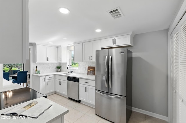 10136 Leisure Ln N Unit 26, Jacksonville, FL 32256 - kitchen featuring stainless steel appliances, a sink, backsplash, light countertops, and light tile patterned floors